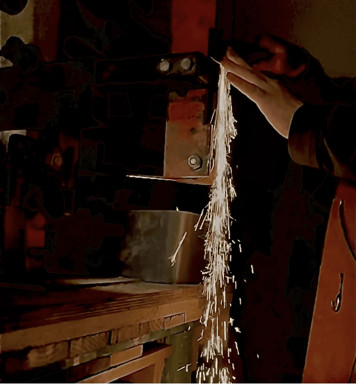 Grinding a knife blade with sparks flying
