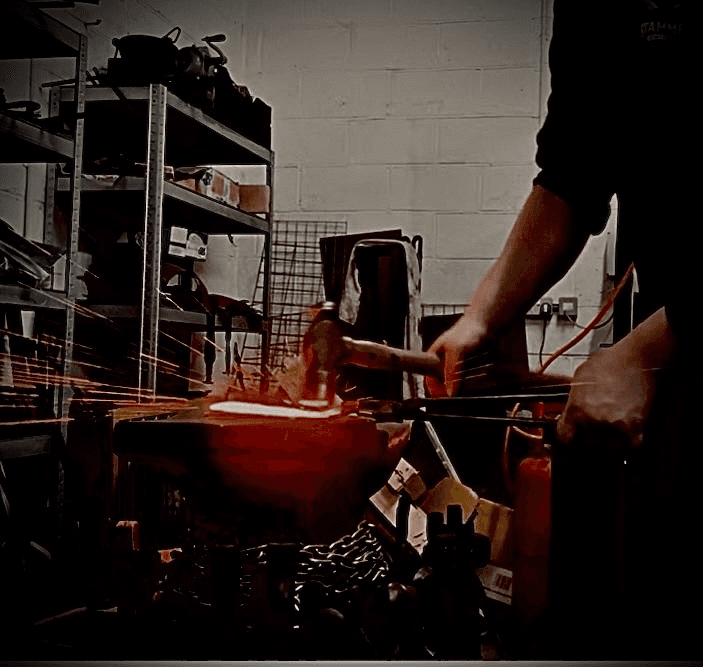 Sparks flying while grinding a knife in the workshop